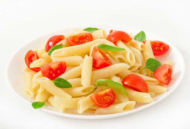 Pasta salad with cherry tomatoes and fresh basil leaves