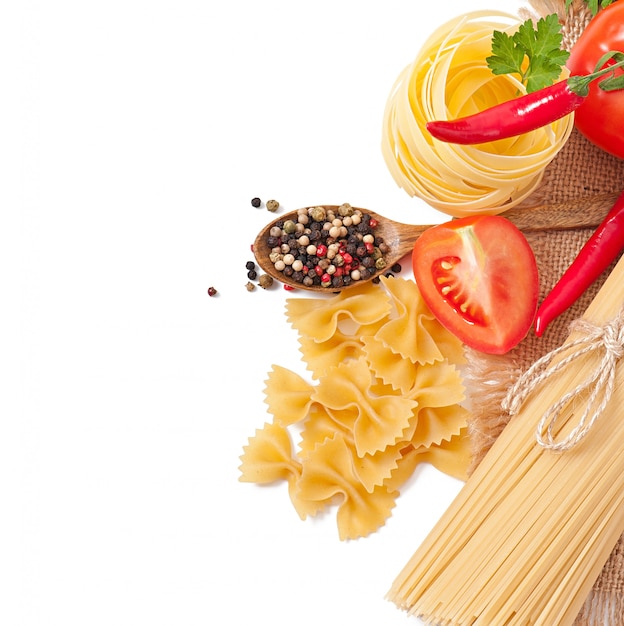 Pasta spaghetti, vegetables, spices isolated on white