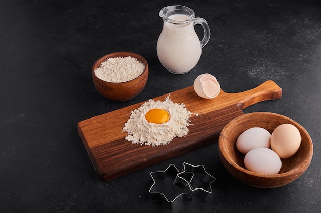 Pastry or bakery making process on wooden board. 