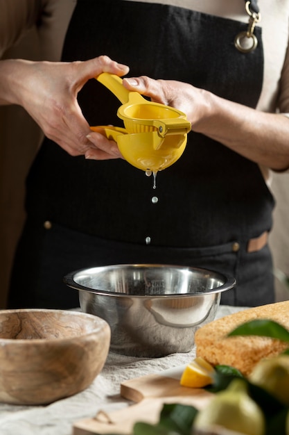 Pastry chef squeezing juice for cake