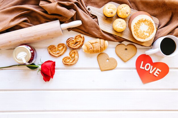 Pastry and rose near brown cloth