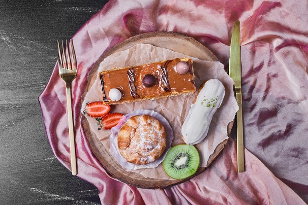 Pastry varieties on a wooden platter .