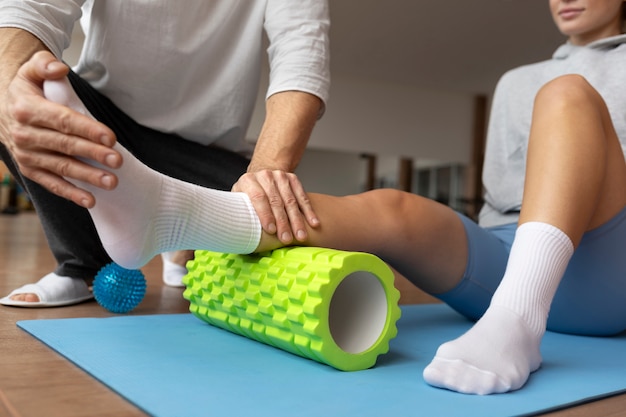 Patient doing physical rehabilitation helped by therapists