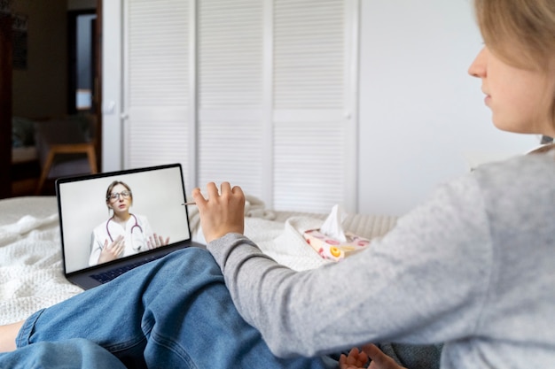 Free photo patient having teleconsultation with doctor