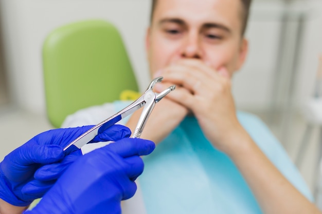 Free photo patient scared by dental equipment