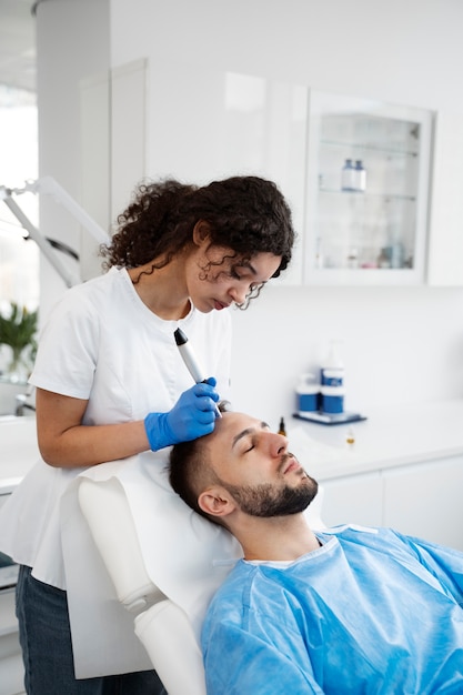 Patient undergoing microneedling procedure