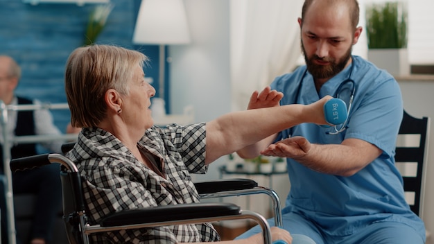 Patient with chronic disease doing physical exercises with dumbbells