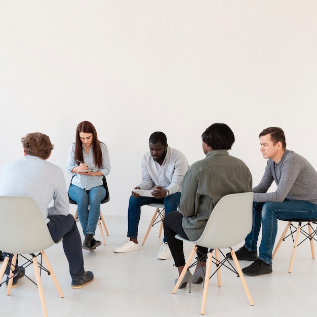 Patients standing in circle and reading