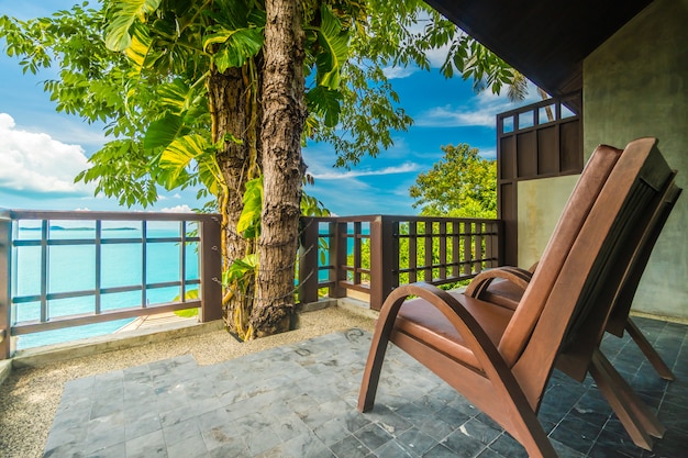 Free photo patio or balcony with chair around sea and ocean view