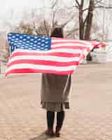 Free photo patriotic woman with american flag at park