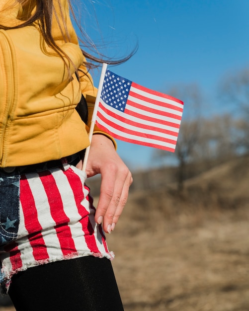 Free photo patriotic woman with small american flag