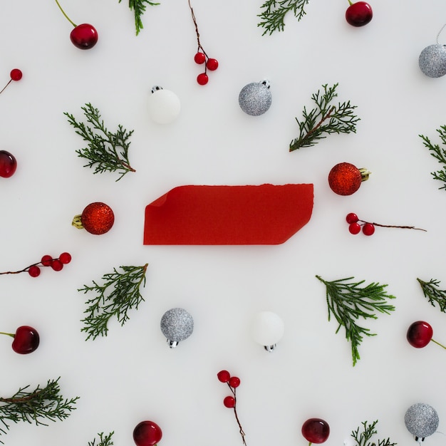 Pattern of christmas ornaments with red empty note 