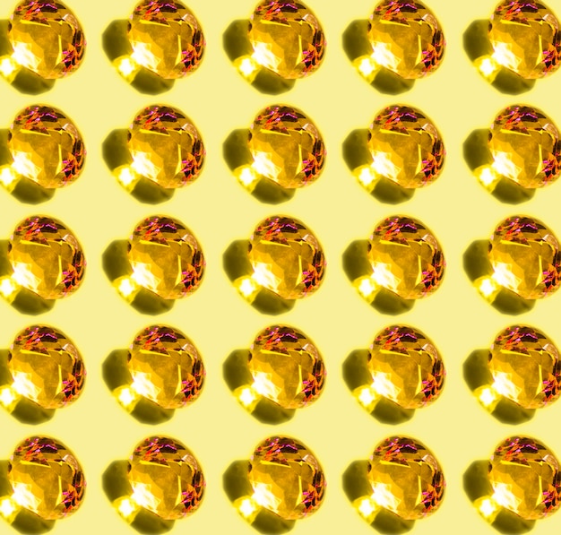 Free photo pattern of shiny glowing diamond with shadow on yellow background