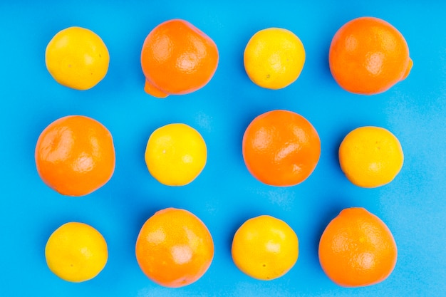 Pattern of whole oranges on blue backdrop