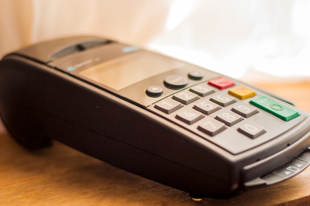 Free Photo payment card in a bank terminal. the concept of of electronic payment.  counter with terminal in supermarket. wireless pos terminal with card waiting for pin