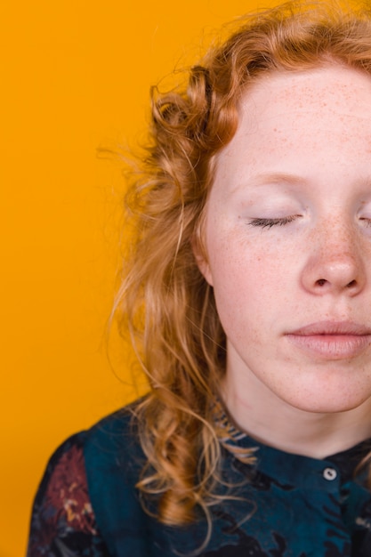 Free Photo peaceful ginger young woman with closed eyes