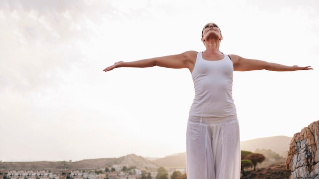 Peaceful woman stretching her arms