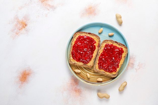 Peanut butter sandwiches or toasts with raspberry jam.