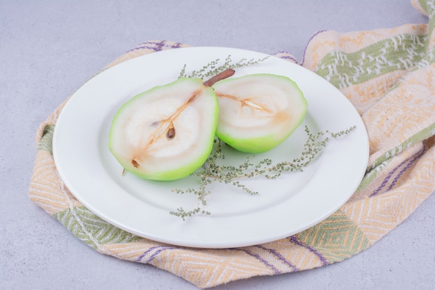 Pear slices with herbs in a white plate