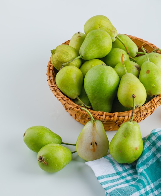 Pears in a basket high angle view on white and kitchen towel