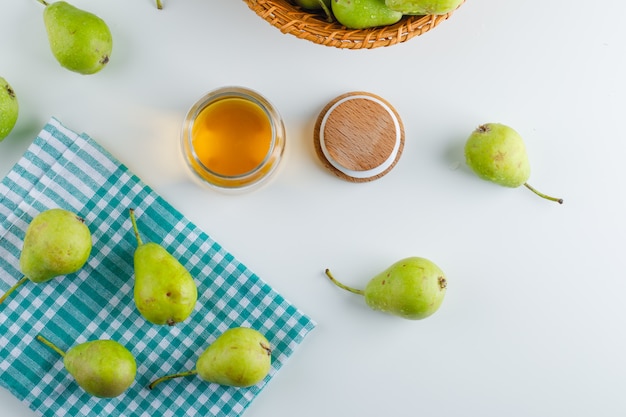 Free Photo pears in a basket with honey top view on white and kitchen towel