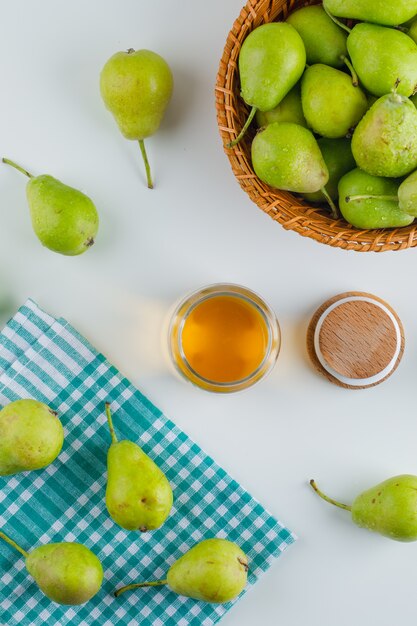 Pears in a basket with honey top view on white and kitchen towel