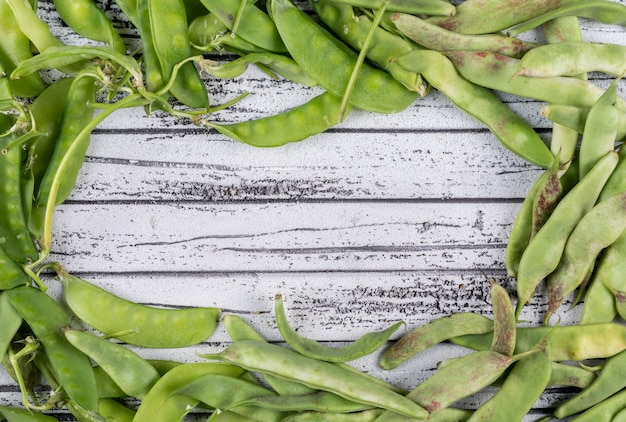 Free Photo peas on a gray wooden table