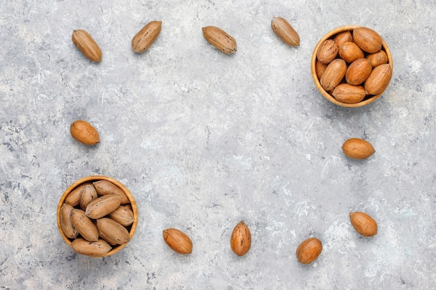 Pecan nuts on light background, top view