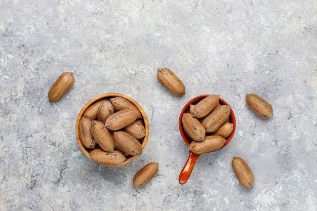 Pecan nuts on light background, top view