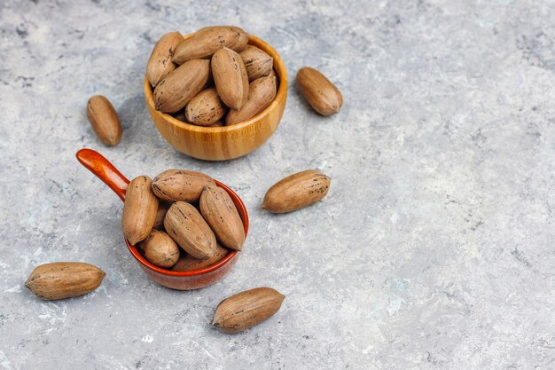 Pecan nuts on light background