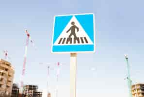 Free photo pedestrians warning sign against construction site