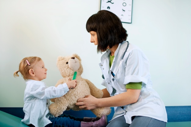 Pediatrician playing with child at doctors office