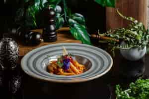 Free photo penne pasta cooked in tomato sauce