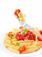 Free photo penne pasta with bolognese sauce, parmesan cheese and basil