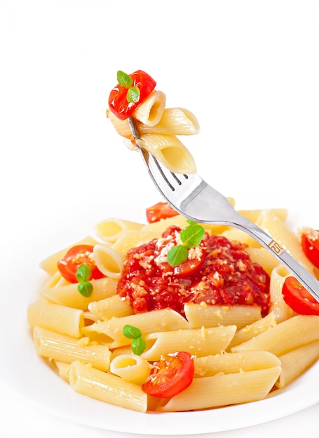 Penne pasta with bolognese sauce, parmesan cheese and basil