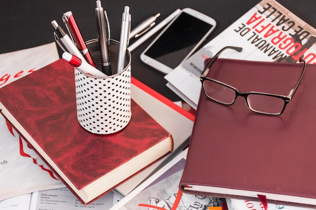 Free photo pens and glasses on books