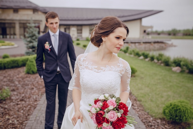 Pensive bride with her husband background