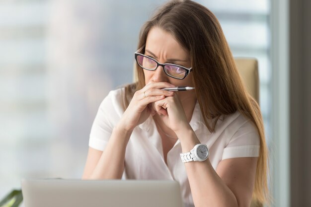 Pensive businesswoman thinking about problem