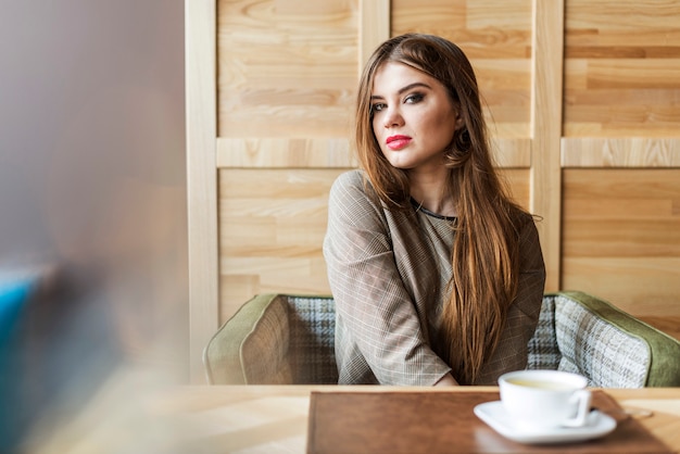 Free photo pensive girl in a coffee shop