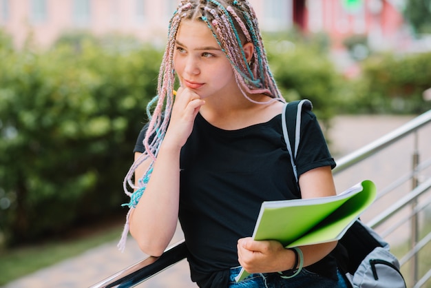 Free Photo pensive girl with textbook