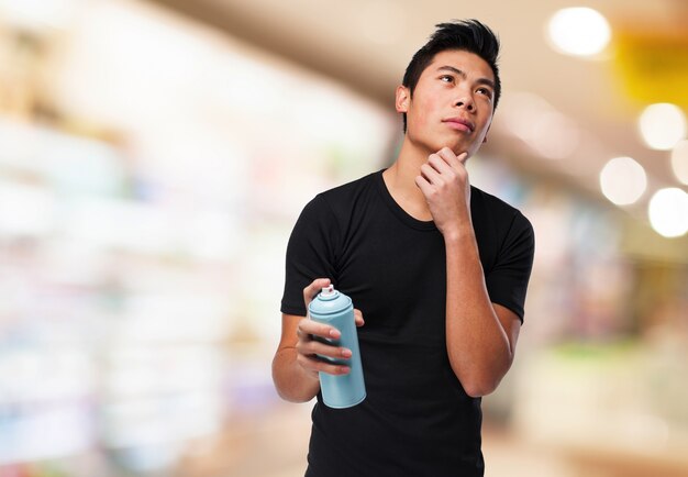 Pensive man with a paint spray can