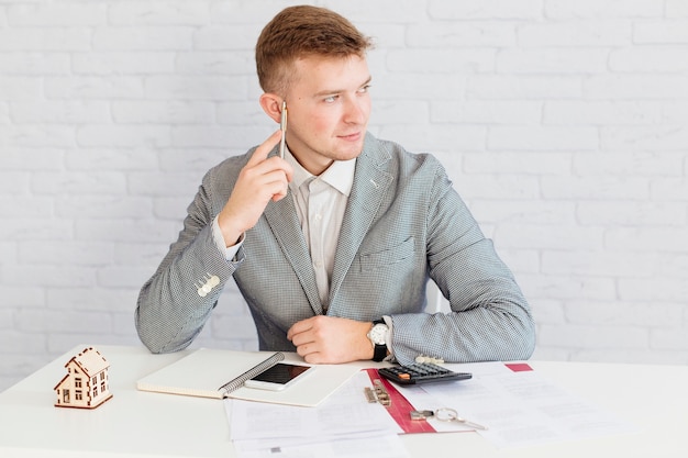 Pensive realtor sitting in office