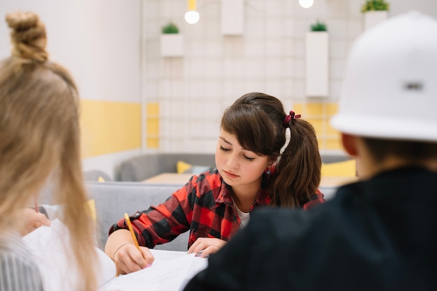 Free Photo pensive schoolgirl studying in class