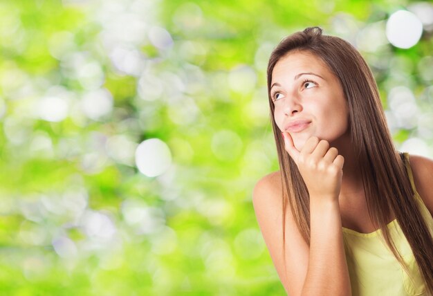 Pensive teenager with hand on chin