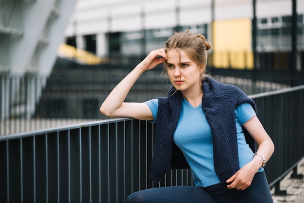 Free photo pensive woman posing at handrail