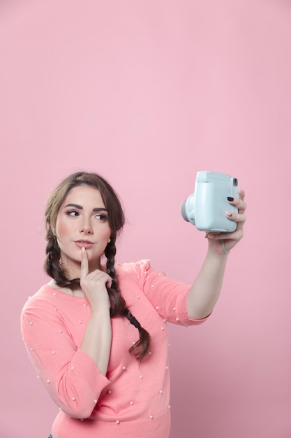 Pensive woman taking a selfie on smartphone