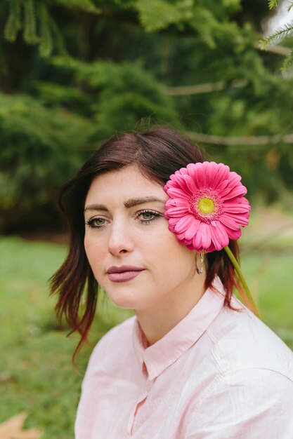 Pensive woman with flower in hair