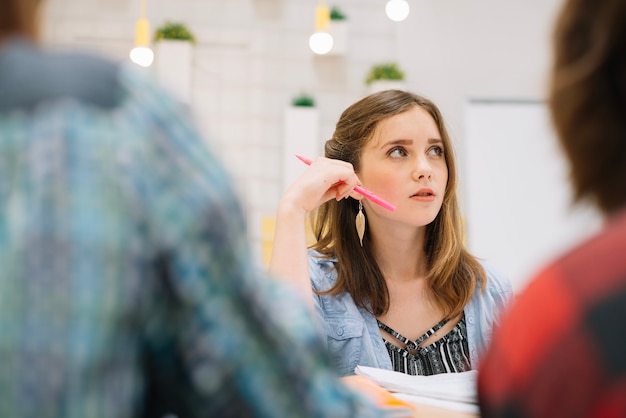 Pensive woman with studies