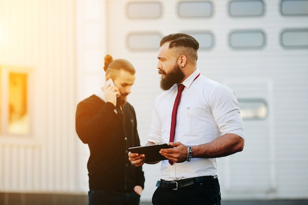 Free photo pensive worker holding a tablet