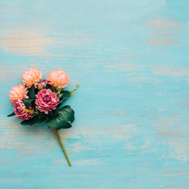 Free photo peonies bouquet on blue wooden background.